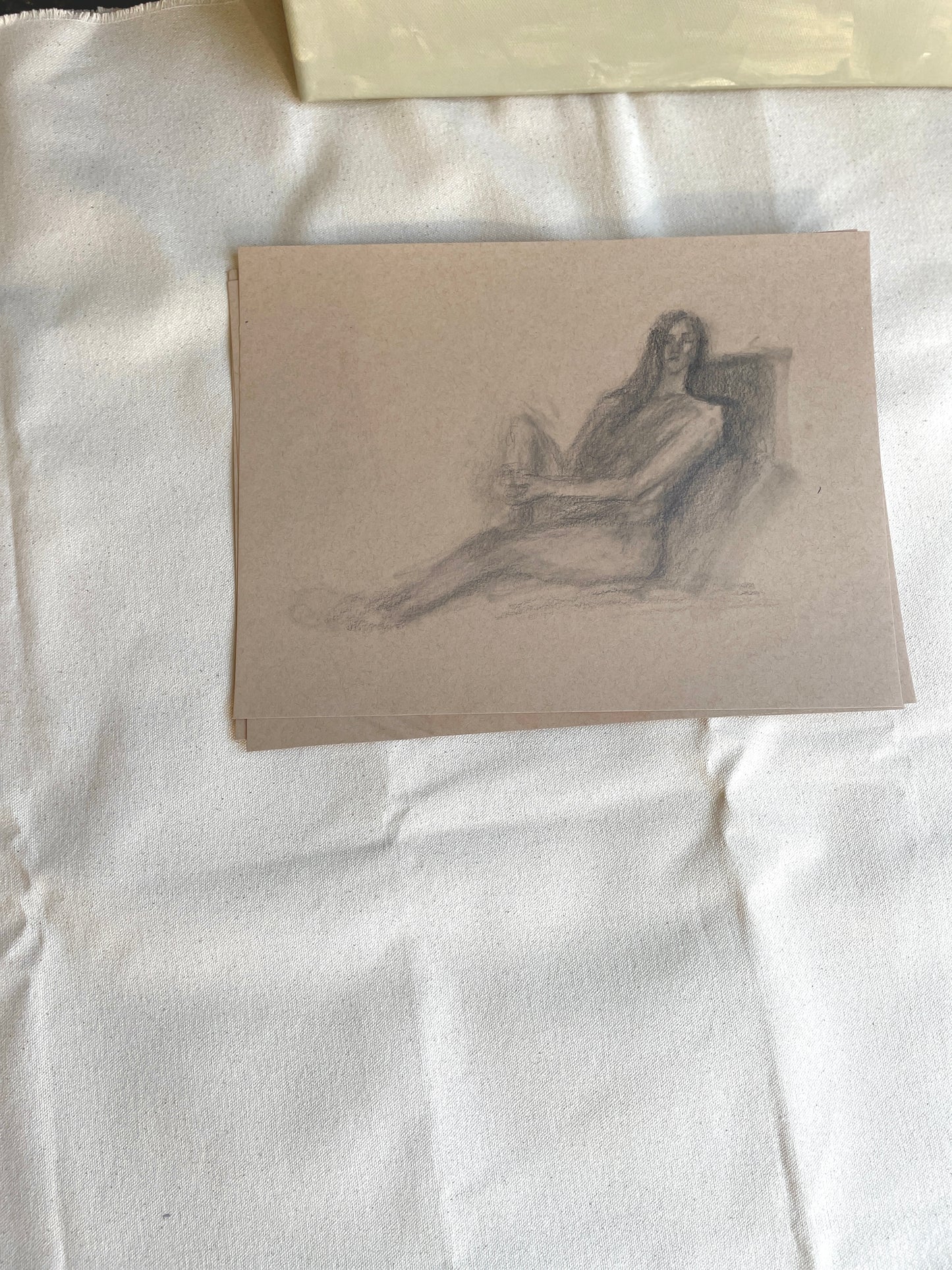 Beige paper figure drawing of a woman in introspective pose