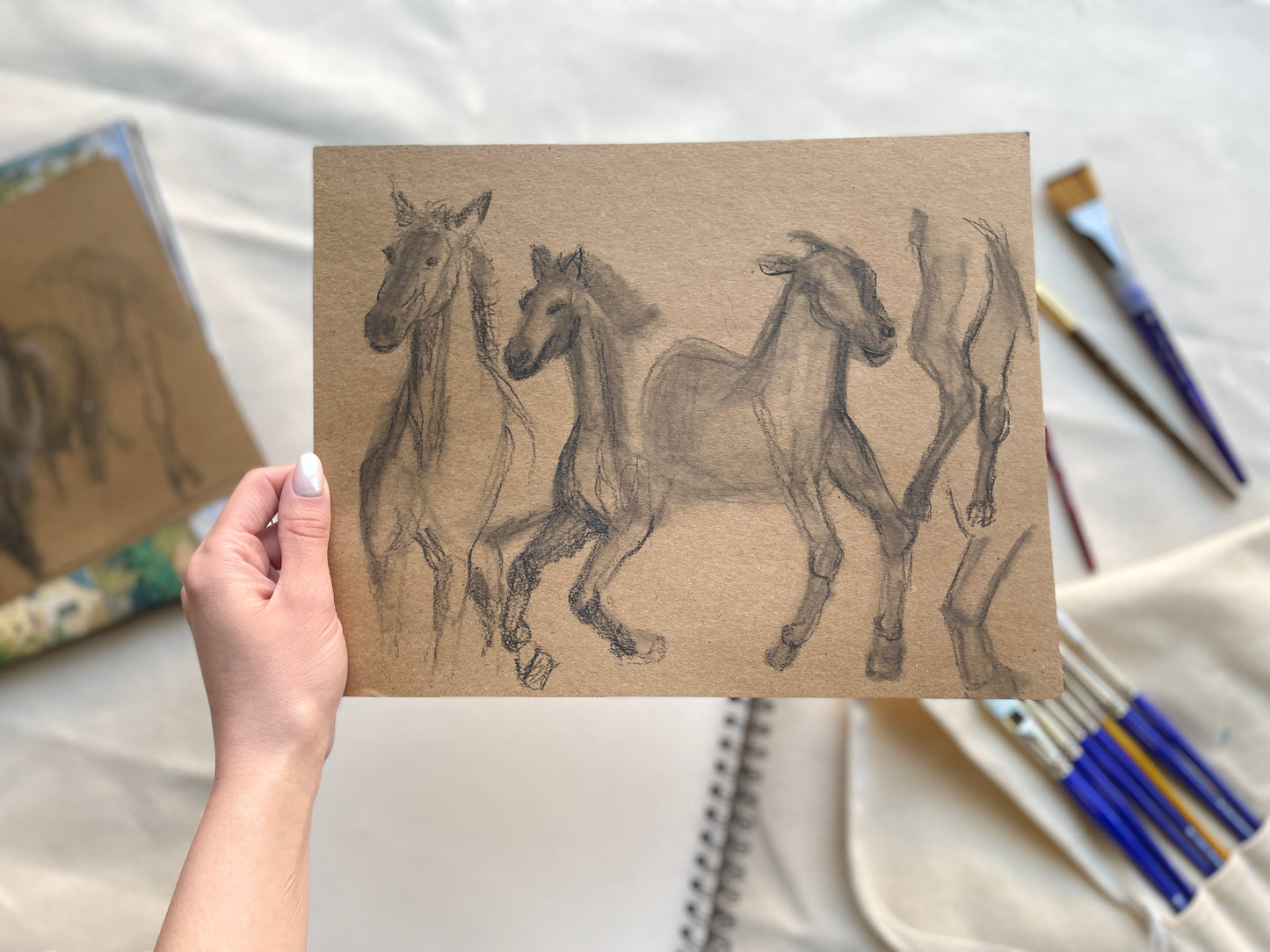 Galloping horses drawing in charcoal and graphite on craft paper